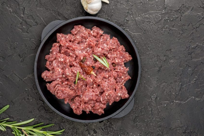 top view meat plate with herbs copy space scaled e